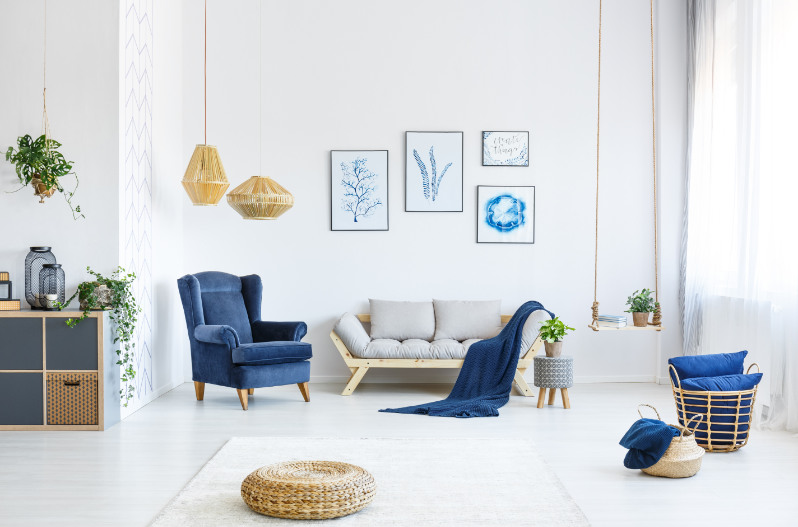 White living room with stylish art and blue color blocking